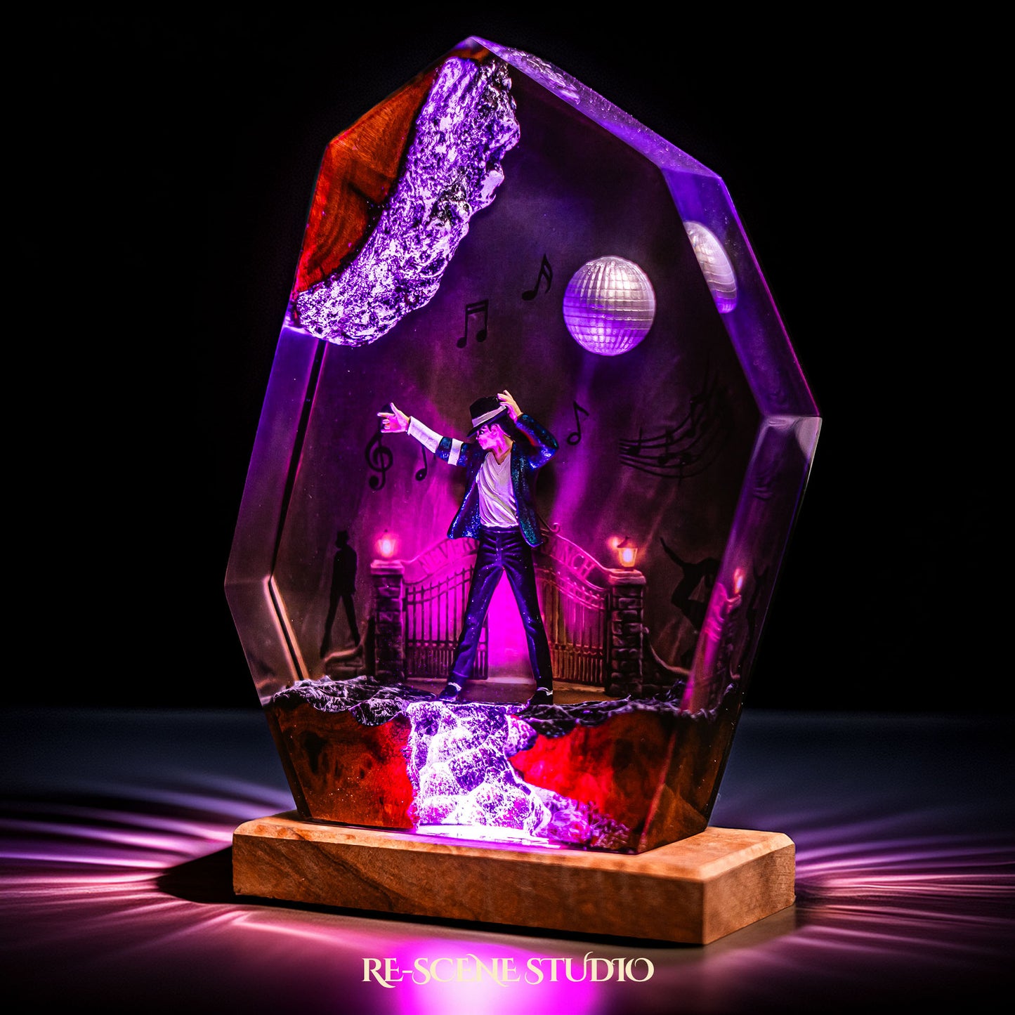 Handmade epoxy resin table lamp showing a dancer on a stage with a mirror ball and floating music notes, one arm raised, glowing from within on a natural wood LED base (view 7)
