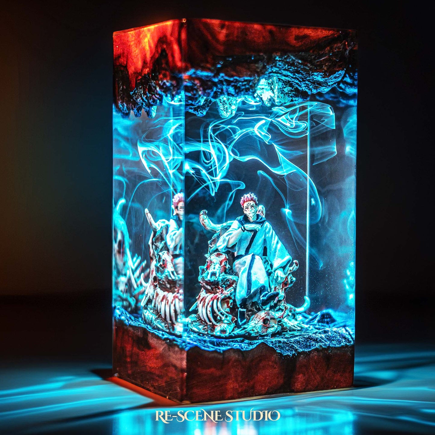 Red-haired curse king among a throne of skulls handmade epoxy resin LED lamp on a wooden base – desk display view