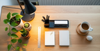 Clean minimalist desk setup with plants and warm task lamp for productivity