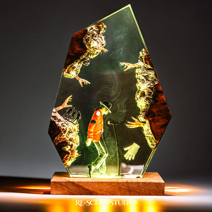 Handmade epoxy resin table lamp showing a dancer in a fedora and red jacket in a dramatic forward anti-gravity lean with reaching shadow hands, on a wood LED base (view 6)