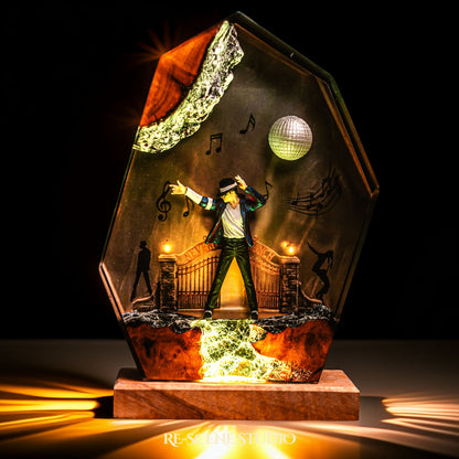 Handmade epoxy resin table lamp showing a dancer on a stage with a mirror ball and floating music notes, one arm raised, glowing from within on a natural wood LED base (view 4)
