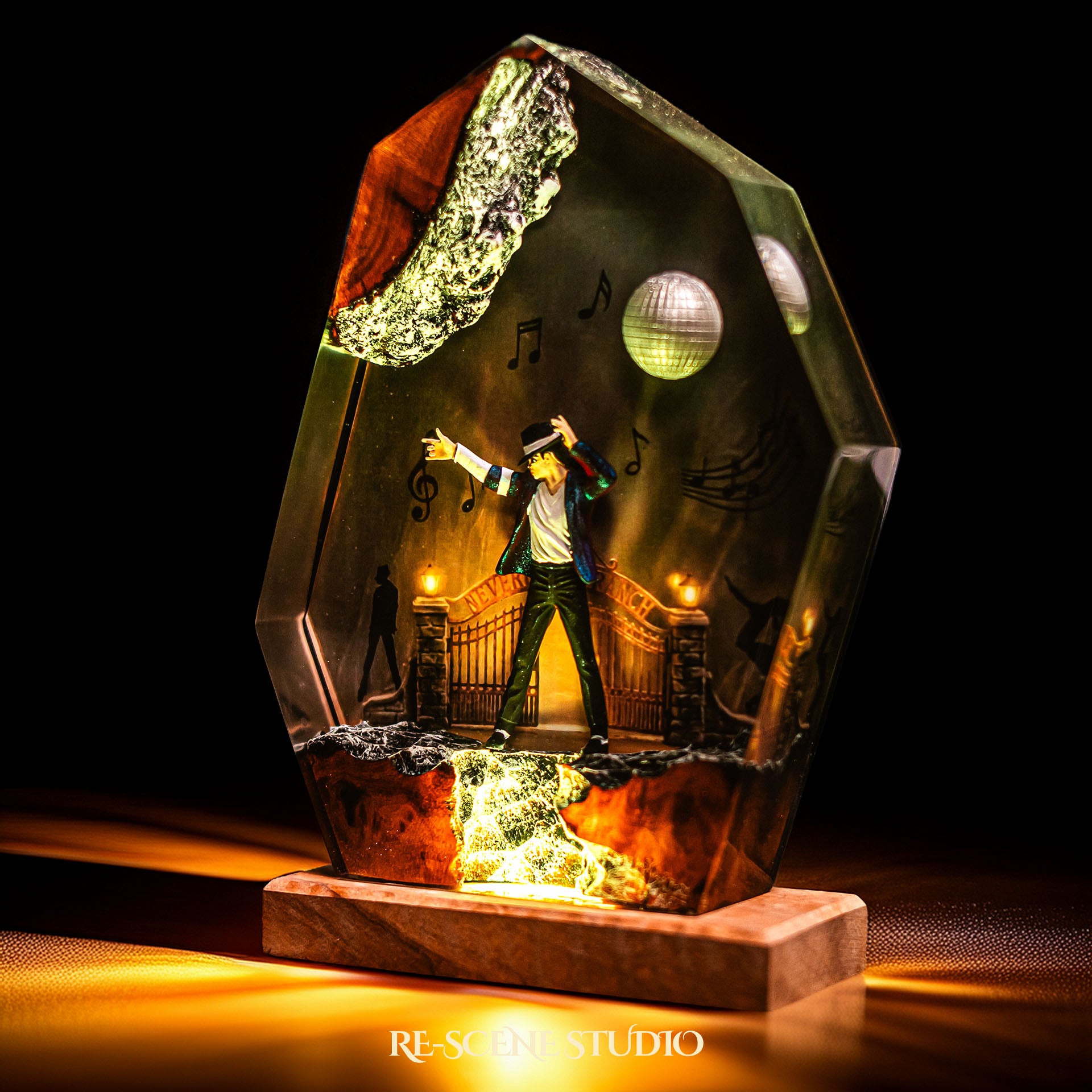 Handmade epoxy resin table lamp showing a dancer on a stage with a mirror ball and floating music notes, one arm raised, glowing from within on a natural wood LED base (view 5)