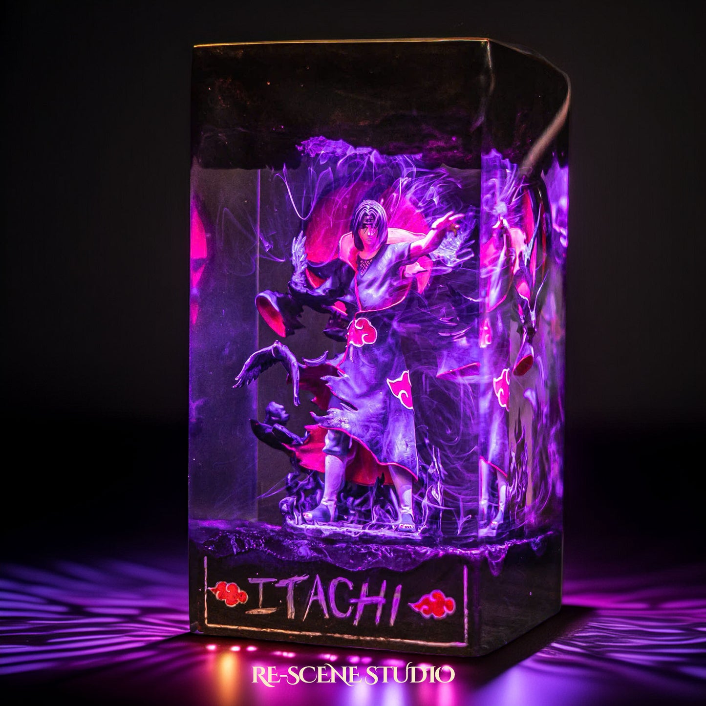 Black-cloaked crow ninja before a crimson moon handmade epoxy resin LED lamp on a wooden base – RGB color glow in a dark room