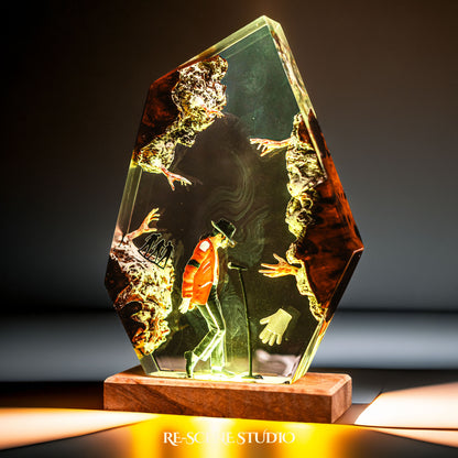 Handmade epoxy resin table lamp showing a dancer in a fedora and red jacket in a dramatic forward anti-gravity lean with reaching shadow hands, on a wood LED base (view 5)