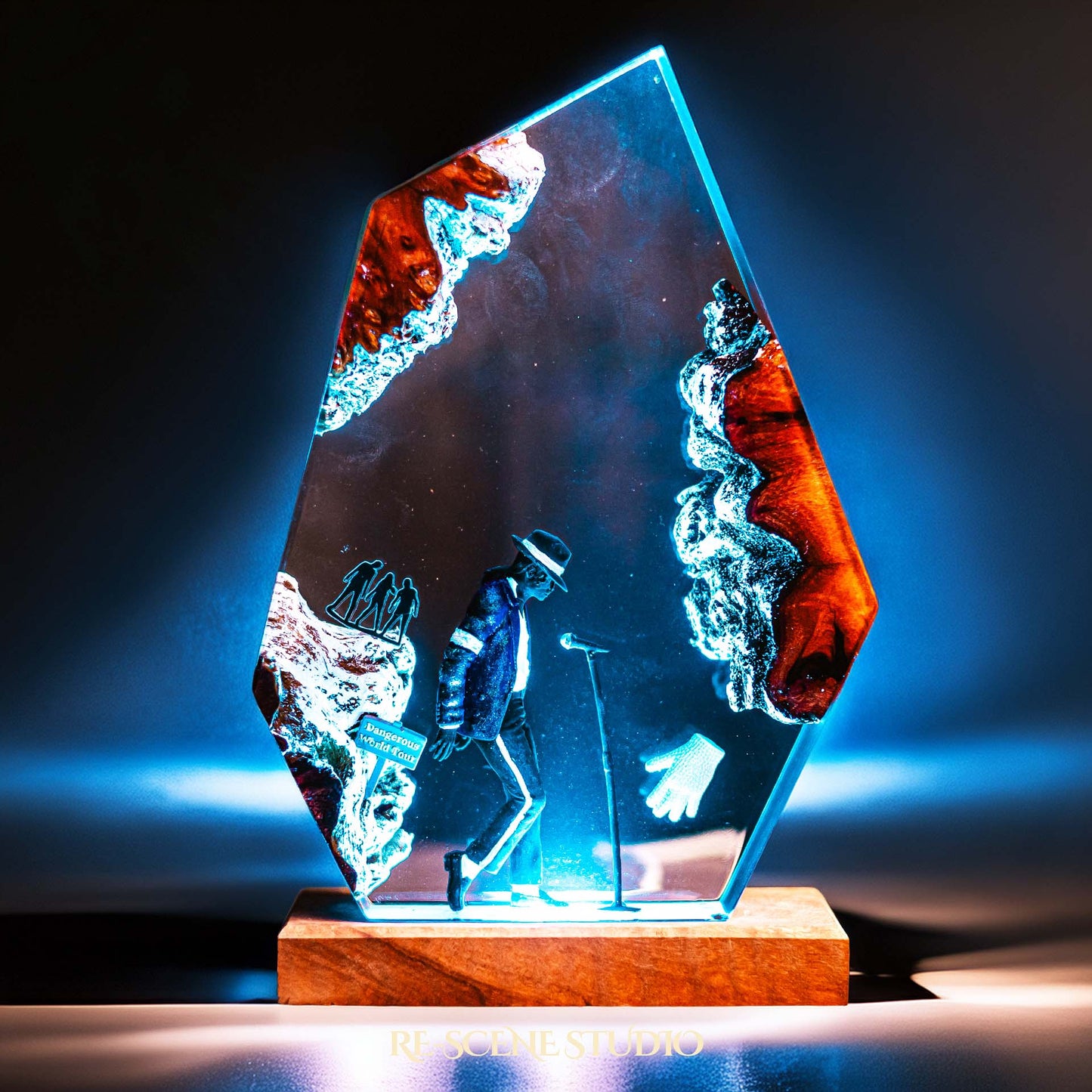 Handmade epoxy resin table lamp showing a dancer in a fedora and sparkling jacket leaning toward a microphone stand under a spotlight, on a natural wood LED base (view 3)