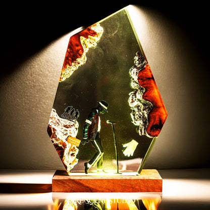 Handmade epoxy resin table lamp showing a dancer in a fedora and sparkling jacket leaning toward a microphone stand under a spotlight, on a natural wood LED base (view 4)