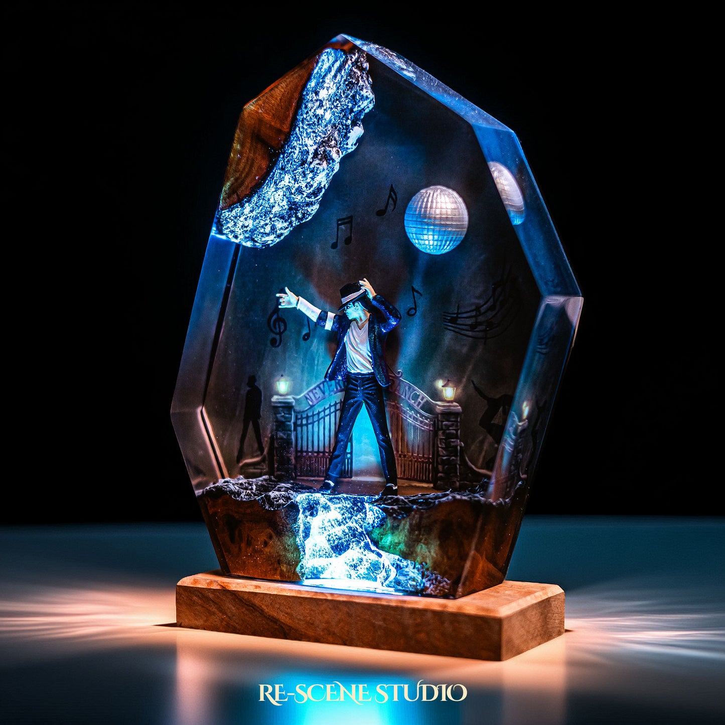 Handmade epoxy resin table lamp showing a dancer on a stage with a mirror ball and floating music notes, one arm raised, glowing from within on a natural wood LED base (view 6)