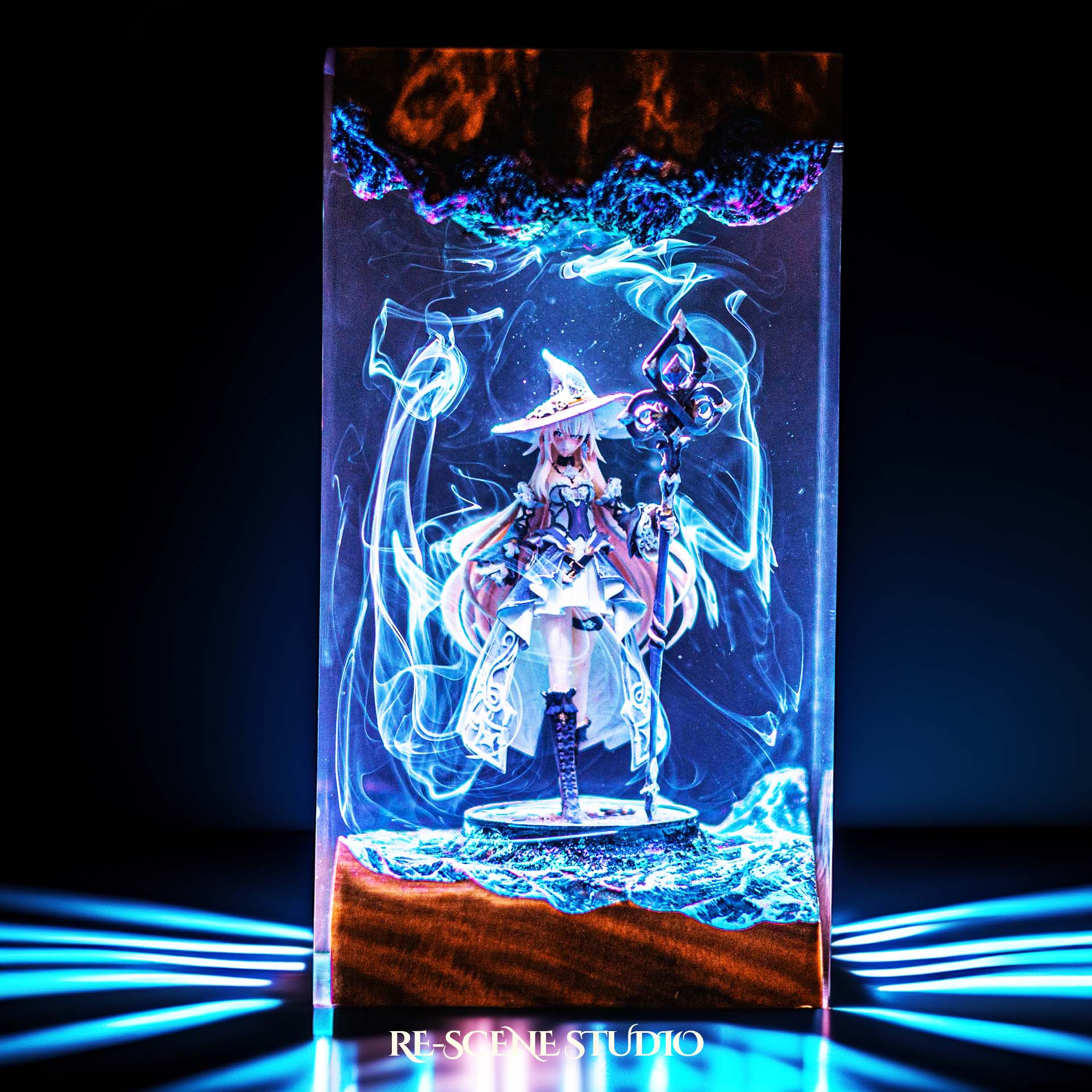 Witch sorceress with a wide hat and glowing staff handmade epoxy resin LED lamp on a wooden base – front view, lit