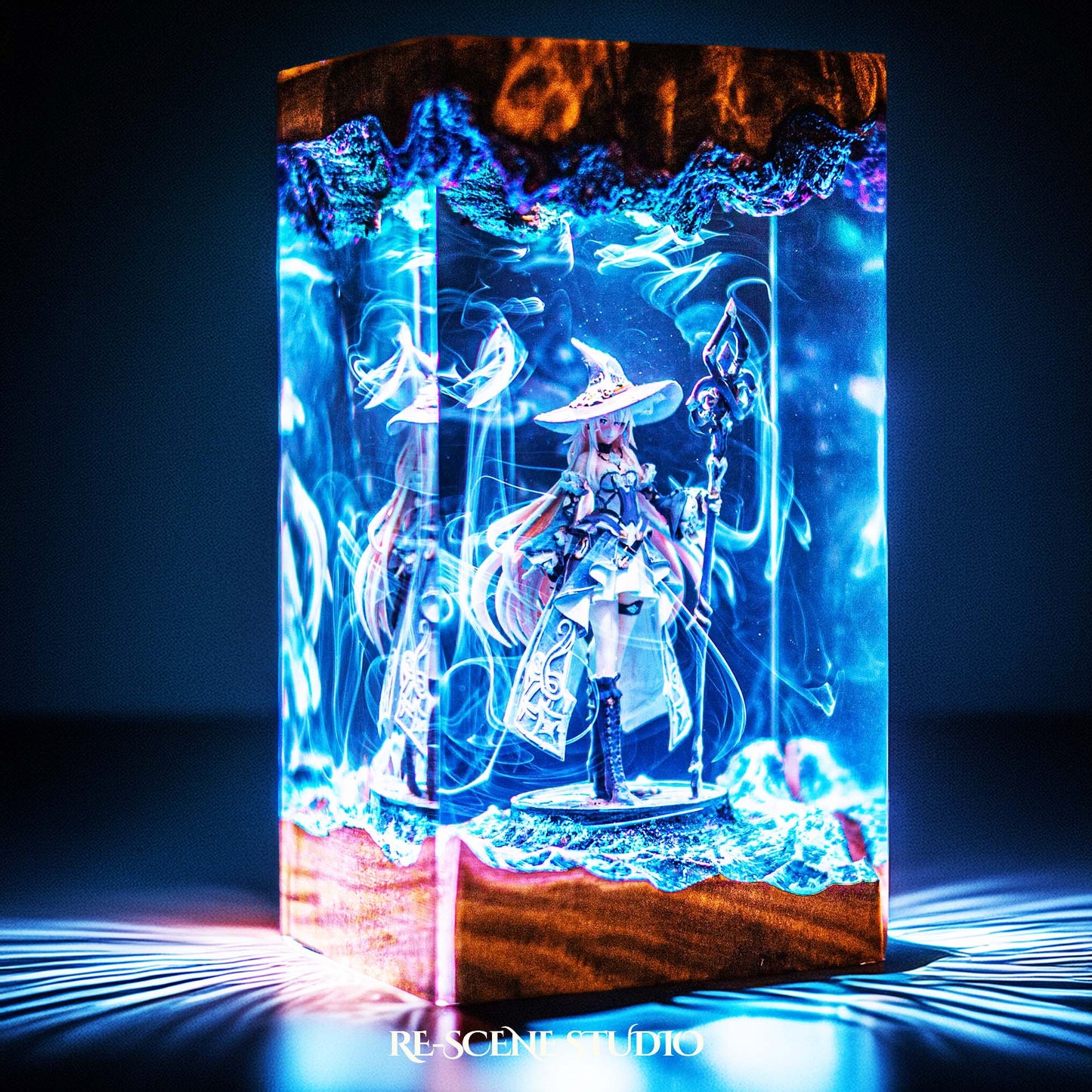 Witch sorceress with a wide hat and glowing staff handmade epoxy resin LED lamp on a wooden base – angled side view