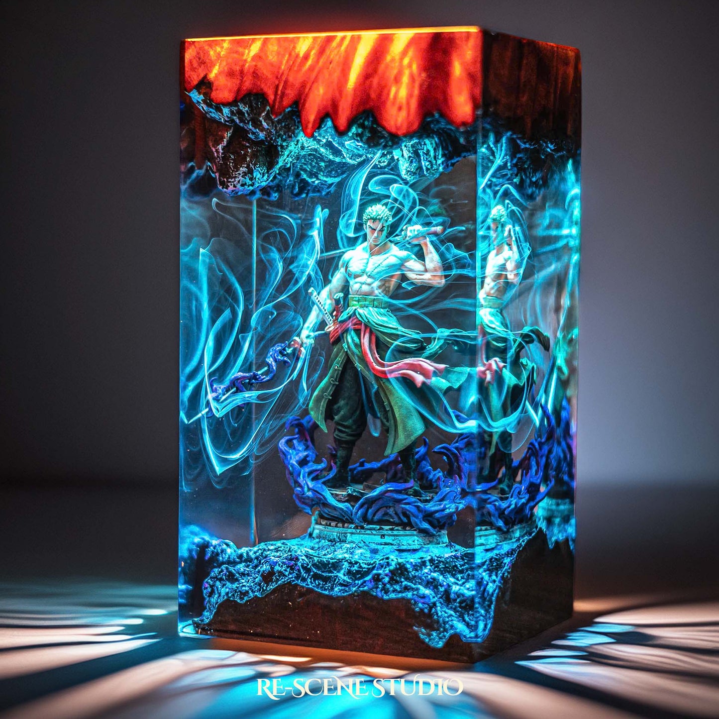 Green-clad three-sword swordsman mid-stance handmade epoxy resin LED lamp on a wooden base – desk display view