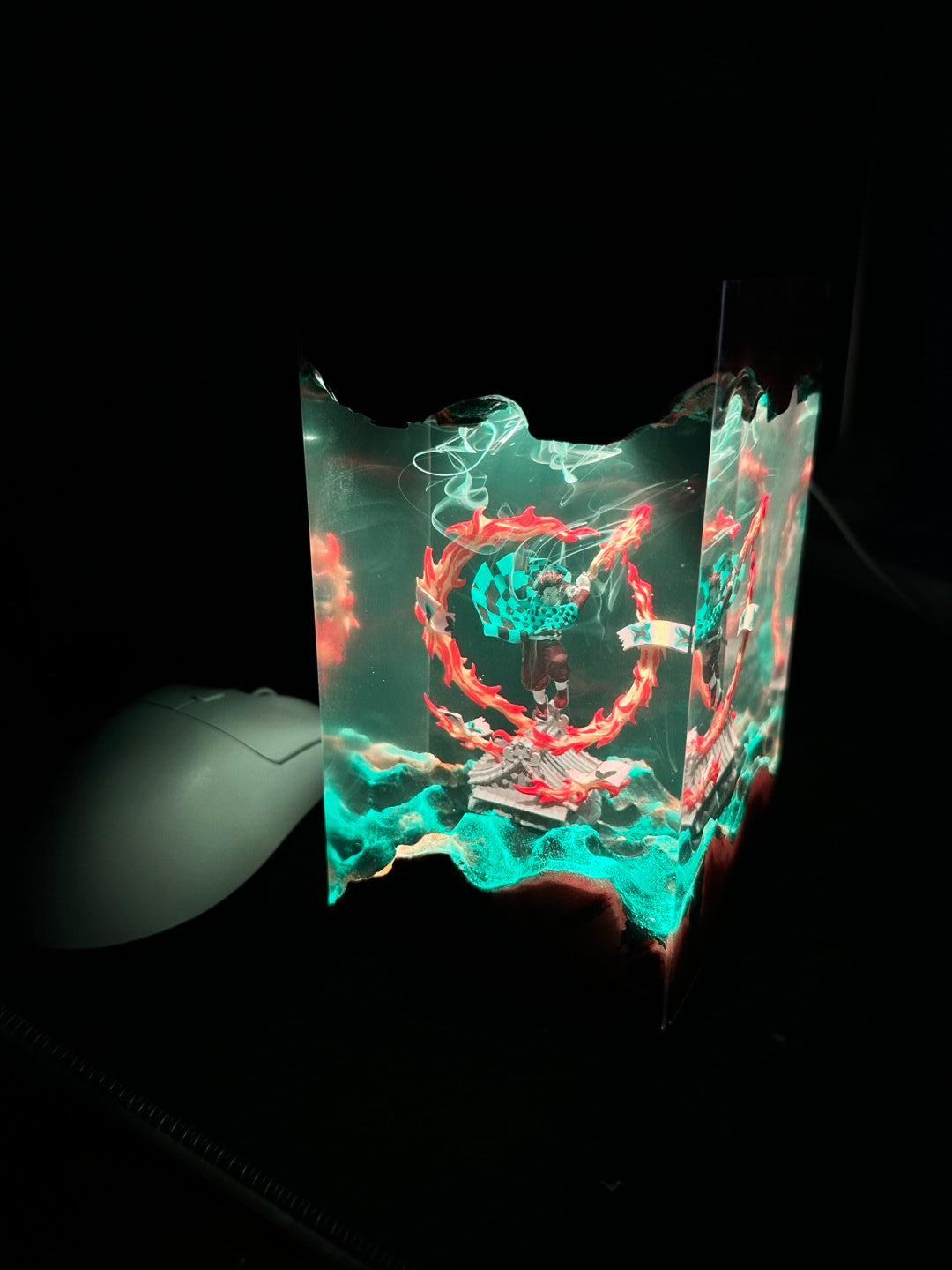 Glass object with colorful abstract design on a black background